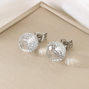 Macro shot of faceted crystal ball earrings with polished titanium steel needles