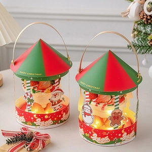 Detail of Christmas cake boxes featuring carousel tops and festive LED light strings