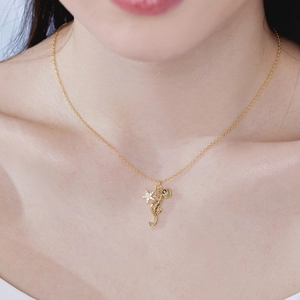 Detailed shot of S925 silver seahorse and starfish necklace worn on neck