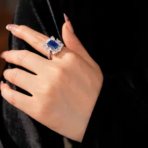 Luxurious open ring with rectangular blue gemstone and sparkling zircon floral clusters