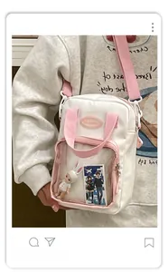 Detailed view of a white and pink Ita bag featuring a clear PVC window for display