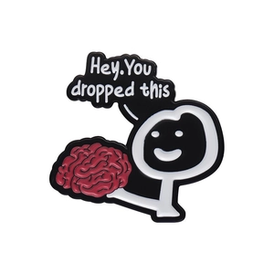 Cartoon stickman enamel pin holding a red brain with Hey You Dropped This message