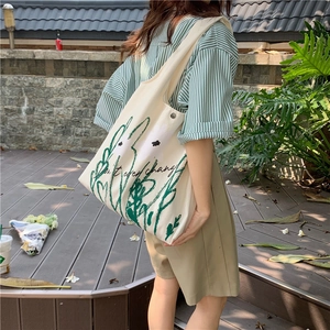 Detail of chamomile print canvas tote bag featuring green hand-drawn plant lines