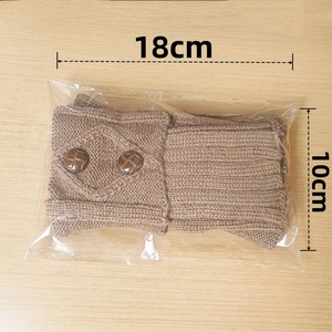 Detail of coffee brown cable knit leg warmers with decorative wood texture buttons
