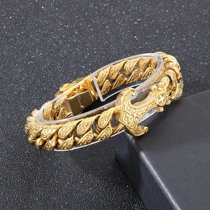 Detailed macro of gold 316L stainless steel Cuban chain with engraved anchor clasp