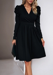 Detail of elegant V-neck black long-sleeve dress with waist pleats and A-line skirt