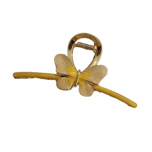 Elegant gold butterfly hair claw clip with yellow enamel gradient and metal finish
