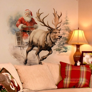 Detail of watercolor Santa Claus and reindeer wall stickers above a cozy living room sofa
