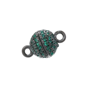 Macro detail of a 6mm sphere magnetic clasp with green zircons and black gold plating