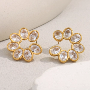 Detailed close-up of 18K gold plated flower stud earrings with oval zircon gemstones