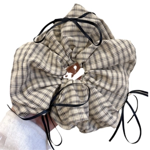 Preppy style beige plaid scrunchie with black ribbon bow for elegant ponytail styling