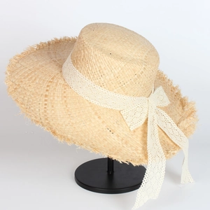 Handmade raffia straw sun hat with elegant lace ribbon bow and frayed wide brim design