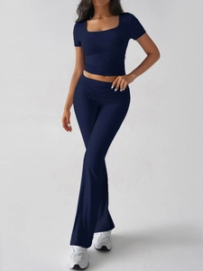 Detail of navy blue cropped short sleeve top and high waisted flared trousers set