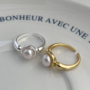 Elegant 925 silver open rings with white pearls in gold and silver finish on a white dish