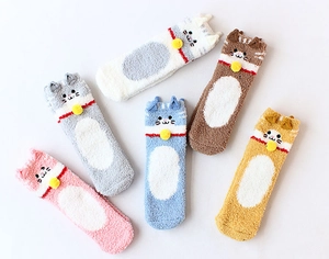 Macro shot of five colors of plush coral fleece cat socks with 3D ears and embroidery
