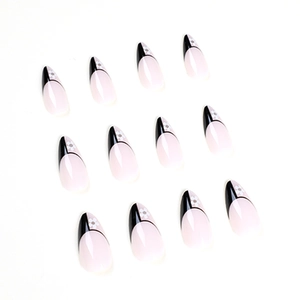 Almond press on nails with black French tips and white floral patterns on nude base
