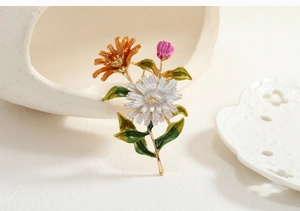Detailed close-up of a floral brooch with colorful enamel petals and gold-tone alloy base