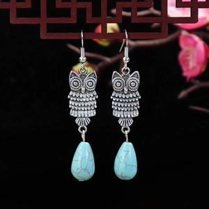 Ethnic vintage turquoise owl drop earrings with silver metal flower details