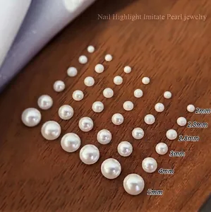 Flatback white glass pearls in sizes 2mm to 5mm for nail art decoration on wood background