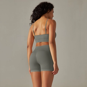 Detail of grey-green seamless knit yoga set showing back profile and high waist shorts