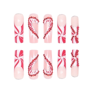 Christmas press-on nails with red candy cane stripes and sparkling rhinestones