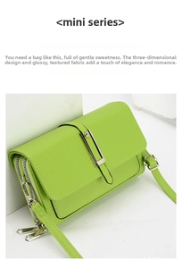 Detail view of the green mini crossbody bag with dual zippers and silver metal buckle