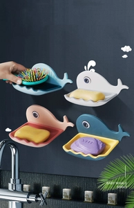 Detail of whale-shaped wall-mounted soap holders with drainage tray in four colors