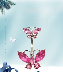 Detail of pink crystal double butterfly navel ring with silver metal finish and stones