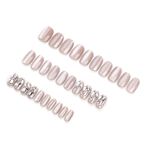 Sparkling pink cat eye press-on nails with rhinestone accents in a short square shape