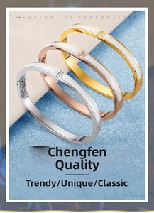 Detail view of tri-color 18K gold plated bangles with white enamel and parallel crystals