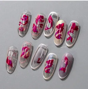 Detail of mermaid aurora laser nail art featuring rose red metallic shell and star patterns