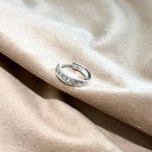 Elegant silver hoop earrings with five channel-set square-cut cubic zirconia crystals