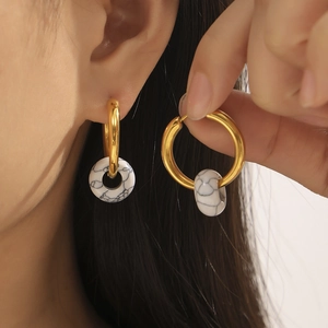 Elegant gold titanium hoop earrings featuring natural white turquoise stone pendants