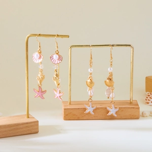 Seashell and starfish drop earrings with pearls on gold metal display stands