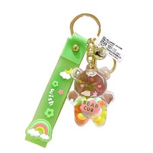 Rainbow acrylic bear liquid oil keychain with green wrist strap on white background