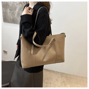 Close-up of khaki large capacity tote bag with long shoulder straps for daily commute
