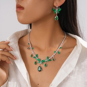Elegant vintage jewelry set with butterfly and green waterdrop pendant on model