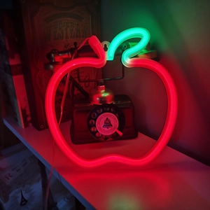 Red apple neon light with green leaf design for Christmas wall decor and cozy ambient lighting