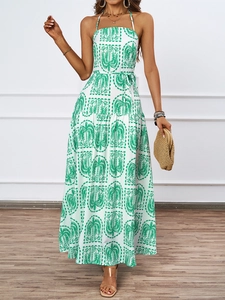 Detail of summer halter dress with palm print and waist tie on flowing fabric