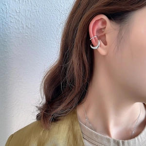 Detail of silver irregular ear cuffs on a model for a minimalist non-pierced look