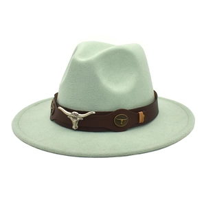 Detail of mint green wool fedora hat featuring a bull head leather band decoration