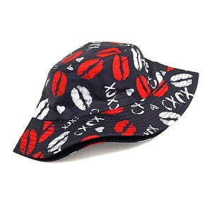 Close-up of black bucket hat with red lips, white hearts, and XOXO graffiti patterns