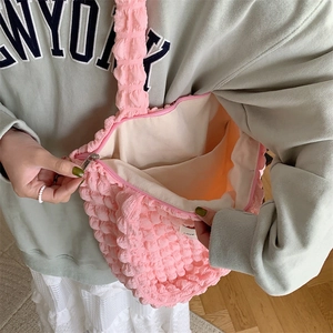 Detail of pink bubble texture tote bag showing inner pocket and zipper closure