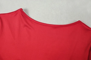 Detailed view of the red satin fabric texture and neat stitching on the round neckline