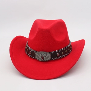 Detail of red cowboy hat featuring silver bull head buckle and star studs on leather band