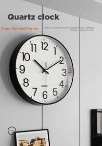 Detail of modern silent quartz wall clock on gray wall showing black frame and 30cm dial