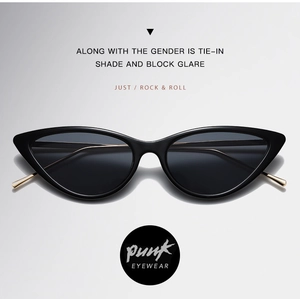Close-up of black cat-eye sunglasses featuring dark grey lenses and gold metal temple tips