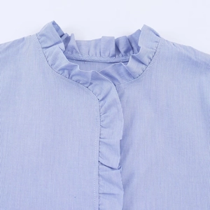 Detail of blue and white striped poplin shirt with elegant ruffled collar and placket
