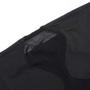 Detailed close-up of the black mesh and knit patchwork with precision stitching