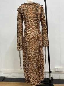 Detail of leopard print chiffon dress featuring ruffled trim and tie-up cuff design